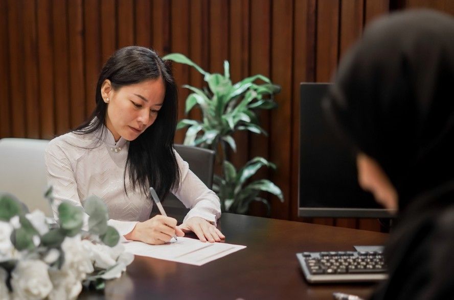 A beautiful bride is signing the paperwork for her court marriage