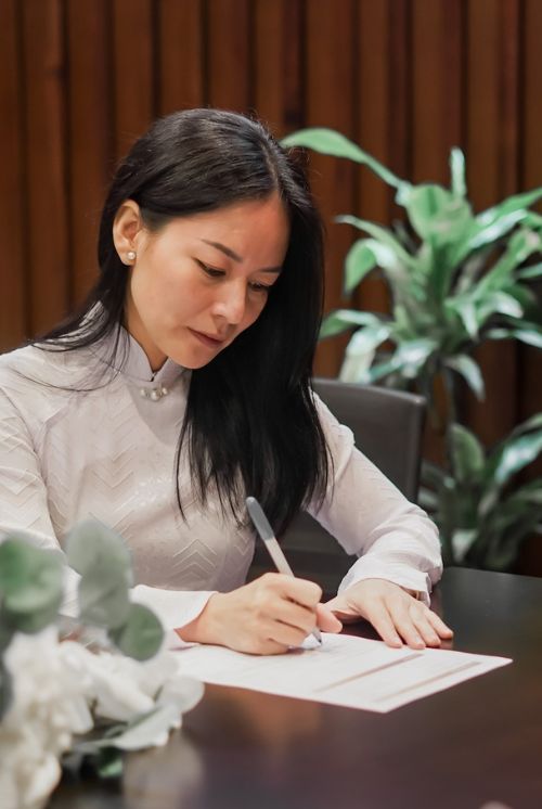 A beautiful bride is signing the paperwork for her court marriage