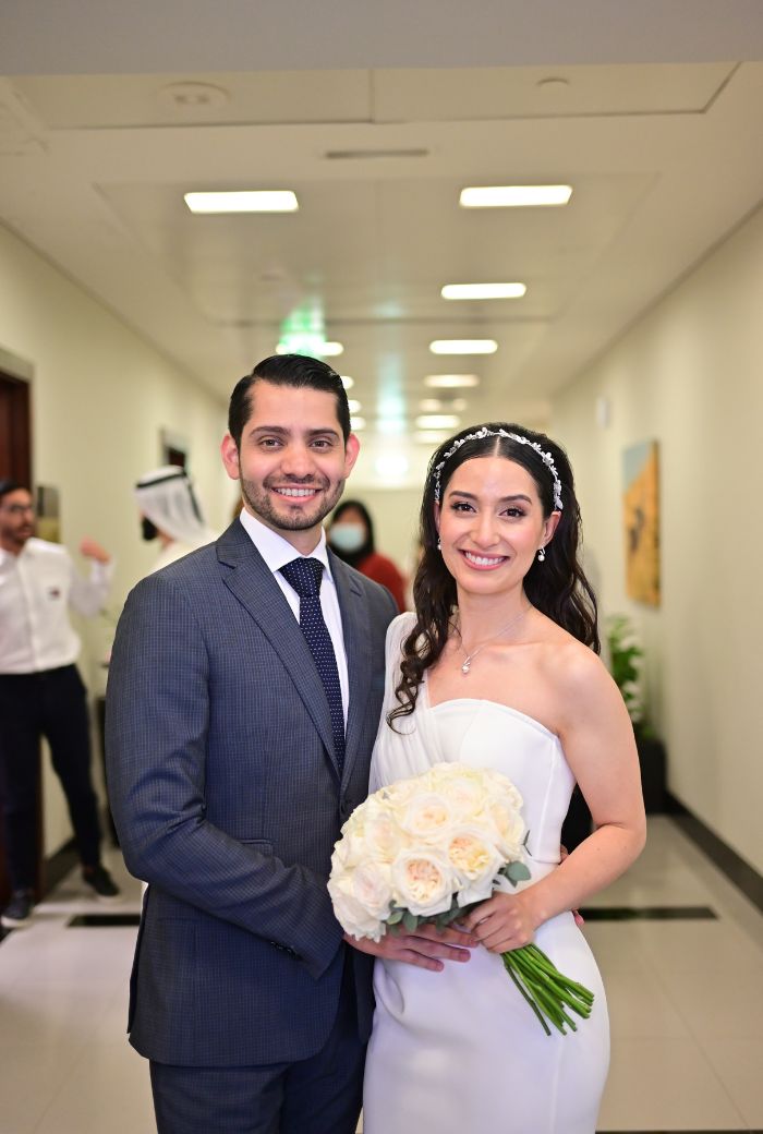 A couple standing for photoshoot after their court marriage